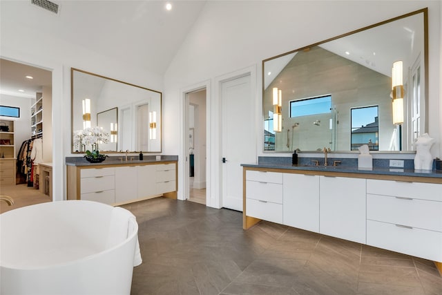 full bath featuring a shower stall, vaulted ceiling, a sink, and visible vents