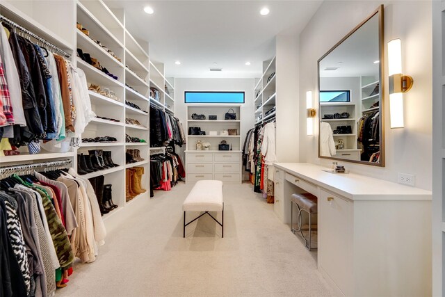 spacious closet with light carpet