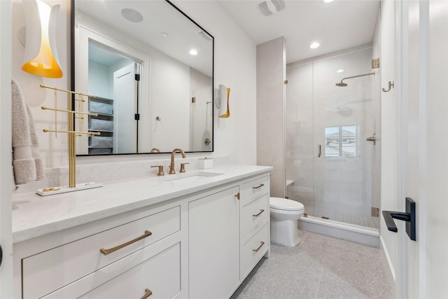 full bath featuring recessed lighting, toilet, vanity, and a stall shower