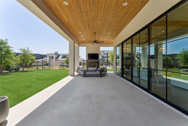 view of patio / terrace with fence, ceiling fan, and a residential view