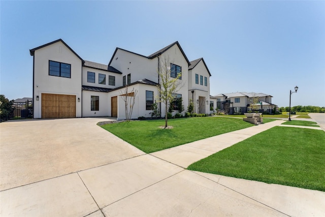 modern inspired farmhouse featuring concrete driveway, an attached garage, a standing seam roof, a front yard, and metal roof