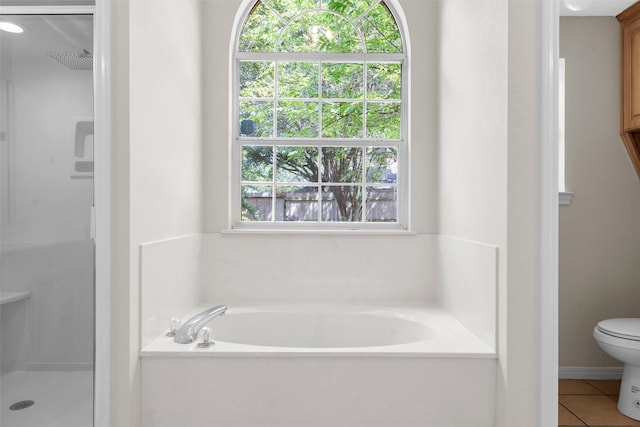 full bath featuring a shower stall, a garden tub, toilet, and tile patterned floors