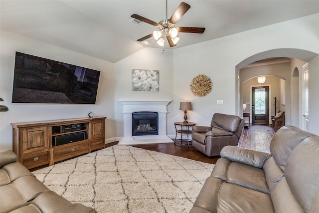 560 Southwestern Dr, Rockwall, TX 75087 - living area with arched walkways, ceiling fan, wood finished floors, lofted ceiling, and a glass covered fireplace