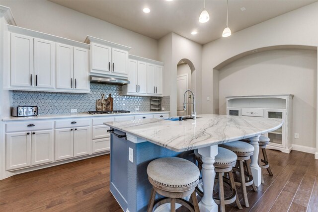 560 Southwestern Dr, Rockwall, TX 75087 - kitchen with a sink, dark wood finished floors, white cabinetry, decorative backsplash, and hanging light fixtures