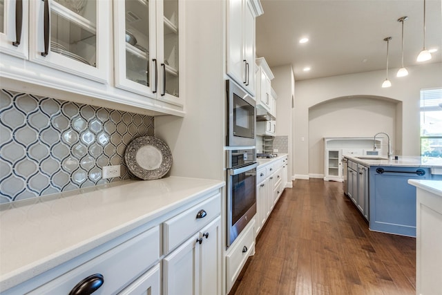 560 Southwestern Dr, Rockwall, TX 75087 - kitchen featuring stainless steel appliances, a sink, decorative backsplash, white cabinetry, and light countertops