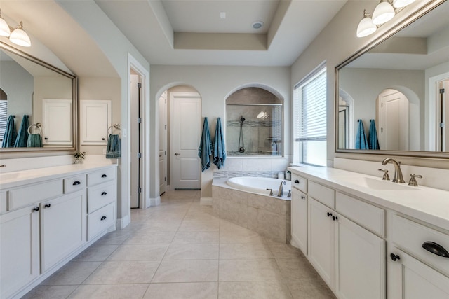 560 Southwestern Dr, Rockwall, TX 75087 - bathroom with a bath, tile patterned flooring, two vanities, and a tray ceiling