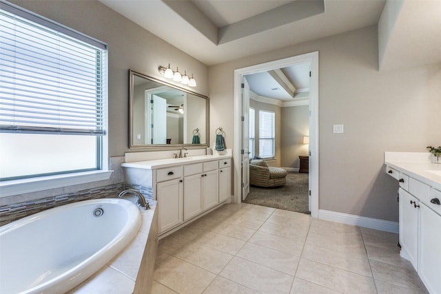 560 Southwestern Dr, Rockwall, TX 75087 - full bathroom featuring vanity, a raised ceiling, a bath, tile patterned flooring, and baseboards