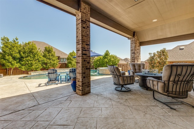 560 Southwestern Dr, Rockwall, TX 75087 - view of patio with a fire pit, an outdoor hot tub, and a fenced backyard