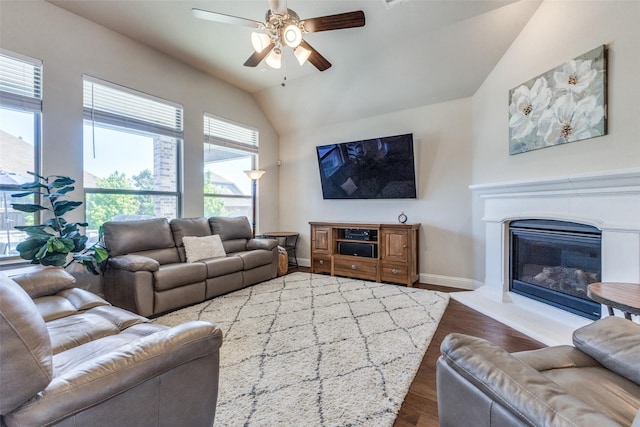 560 Southwestern Dr, Rockwall, TX 75087 - living room with ceiling fan, wood finished floors, lofted ceiling, a glass covered fireplace, and baseboards