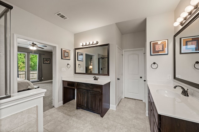ensuite bathroom featuring tile patterned floors, visible vents, and a sink