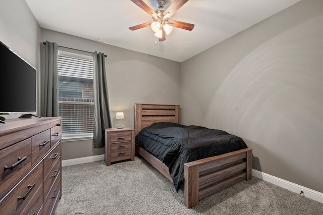 bedroom featuring light colored carpet, ceiling fan, and baseboards