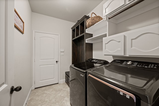 laundry room featuring light tile patterned floors, washing machine and clothes dryer, laundry area, and baseboards