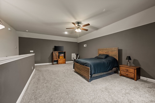 bedroom with light colored carpet, baseboards, and a ceiling fan