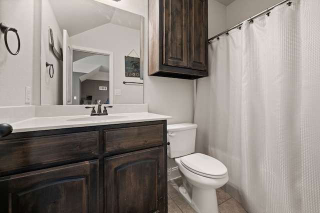 bathroom featuring tile patterned flooring, toilet, and vanity