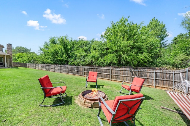 view of yard featuring a fenced backyard and an outdoor fire pit