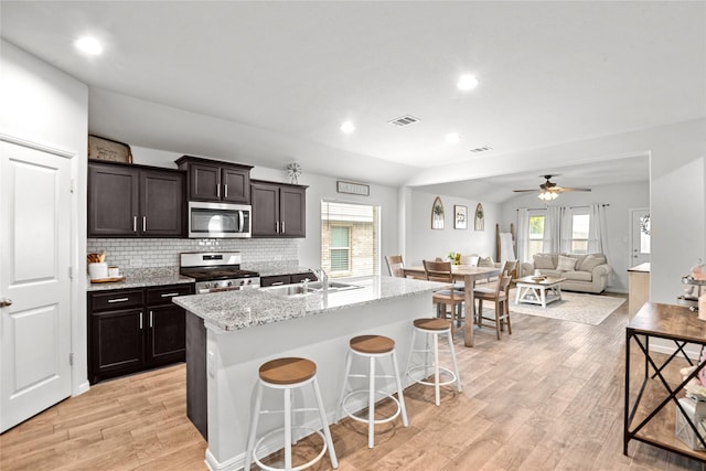 4629 Fringetree Way, Fort Worth, TX 76036 - kitchen featuring a sink, decorative backsplash, light wood finished floors, appliances with stainless steel finishes, and visible vents