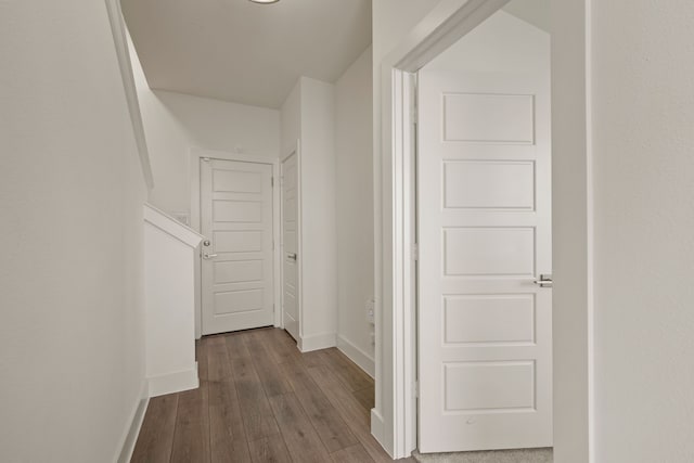 hall with baseboards and dark wood-style floors