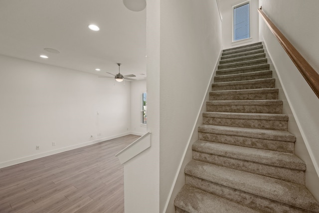 stairs with recessed lighting, wood finished floors, baseboards, and ceiling fan