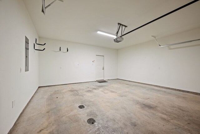 garage featuring electric panel and a garage door opener