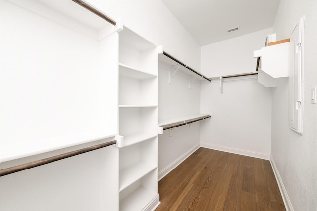 spacious closet with visible vents and dark wood-type flooring