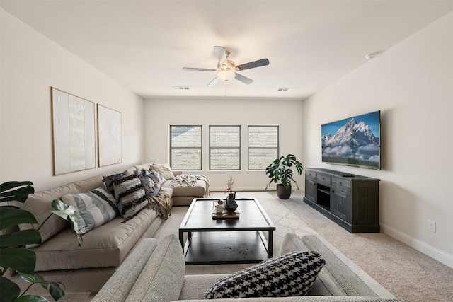 living area featuring ceiling fan, light colored carpet, baseboards, and visible vents