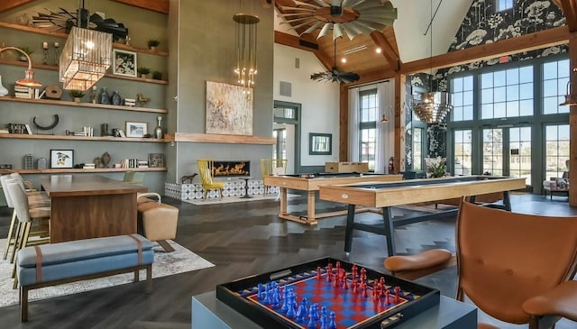 interior space with visible vents, ceiling fan, high vaulted ceiling, and a fireplace