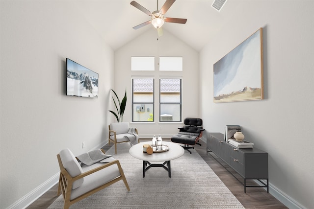 sitting room with visible vents, dark wood-style flooring, ceiling fan, and vaulted ceiling