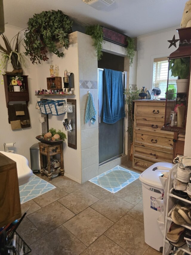 full bathroom with a shower stall, crown molding, and visible vents