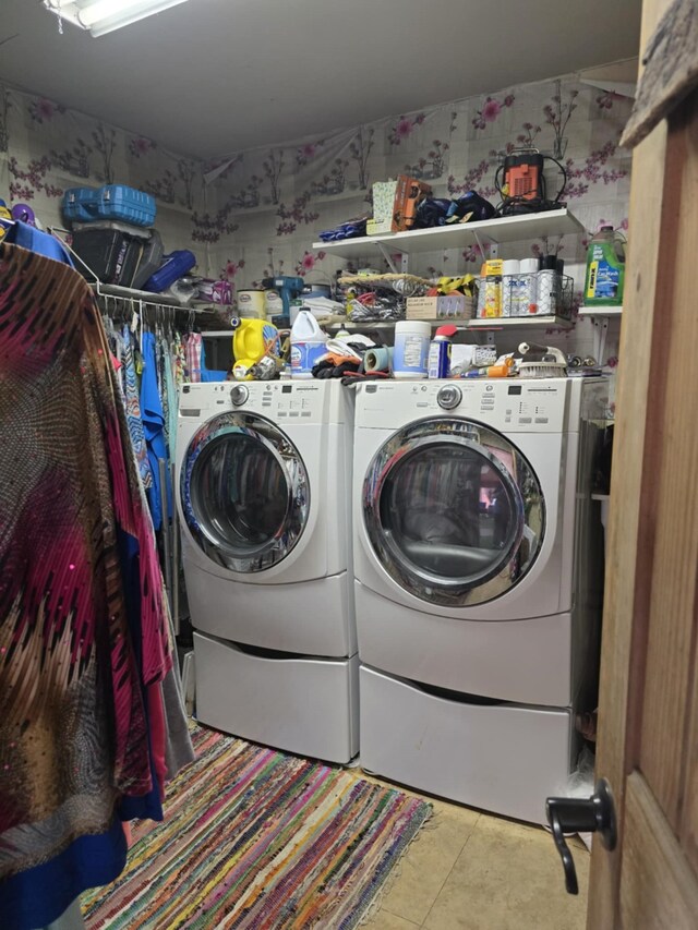 laundry area with independent washer and dryer, tile patterned floors, and laundry area