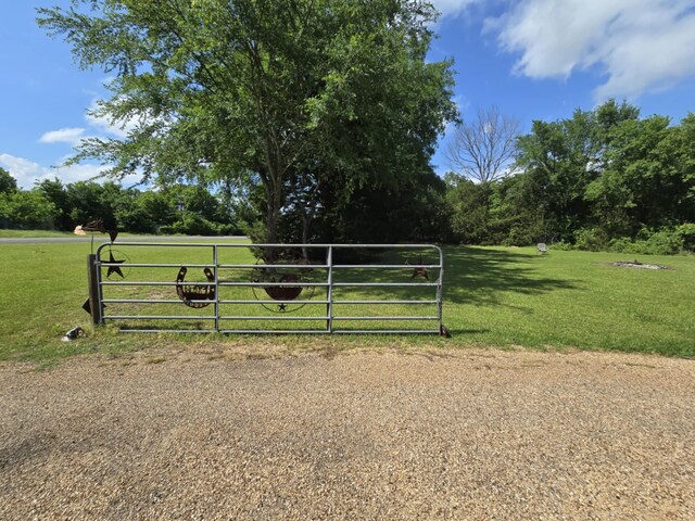 view of gate featuring a yard