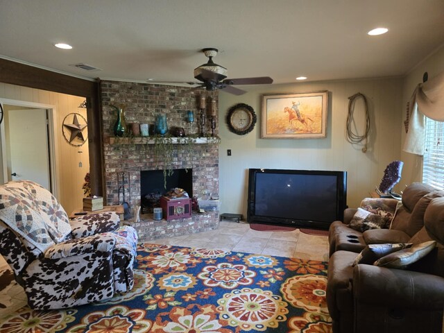 tiled living area featuring a ceiling fan, crown molding, a brick fireplace, visible vents, and recessed lighting