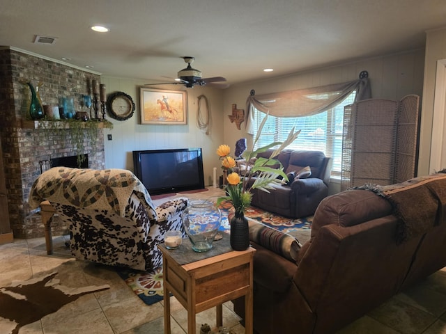 living room with recessed lighting, visible vents, a ceiling fan, crown molding, and a fireplace