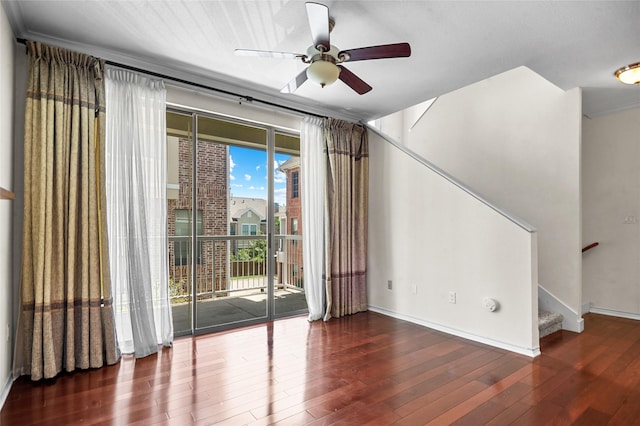 interior space with stairway, ceiling fan, baseboards, and hardwood / wood-style floors