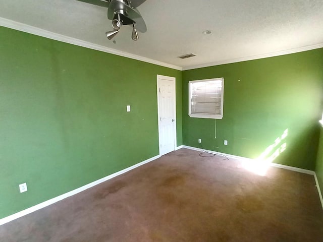 carpeted empty room with visible vents, ceiling fan, baseboards, and ornamental molding