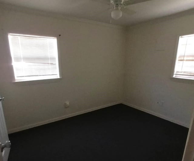 spare room featuring baseboards, ceiling fan, and crown molding