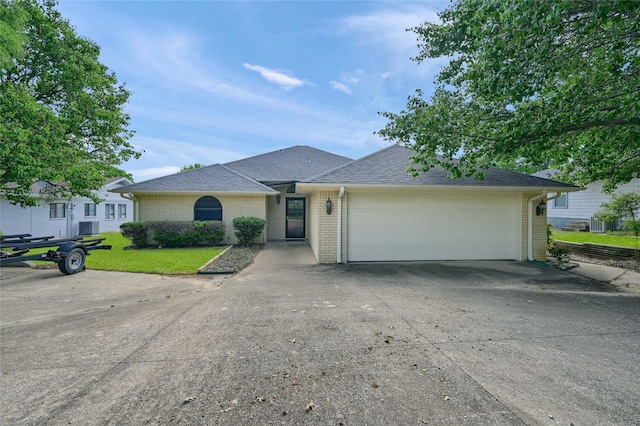 511 Kiowa Dr W, Lake Kiowa, TX 76240 - ranch-style house featuring driveway, brick siding, a front yard, and a garage