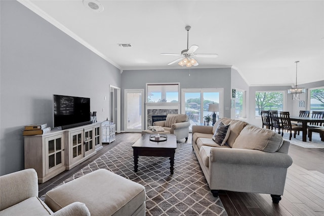 511 Kiowa Dr W, Lake Kiowa, TX 76240 - living area with visible vents, dark wood-style flooring, crown molding, a fireplace, and ceiling fan