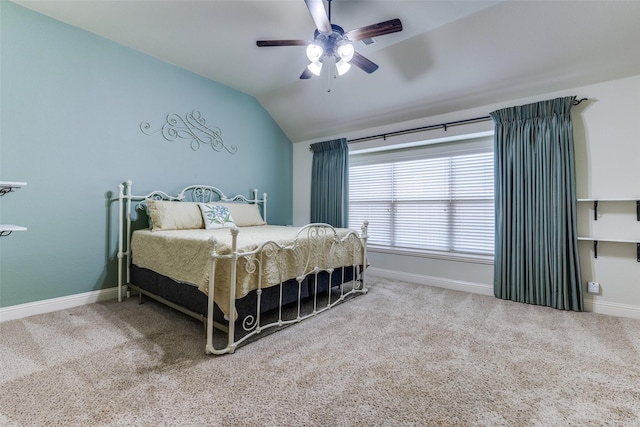 carpeted bedroom with baseboards, a ceiling fan, and vaulted ceiling