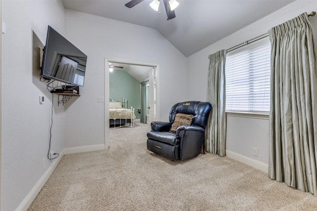 living area with baseboards, a ceiling fan, carpet, and lofted ceiling