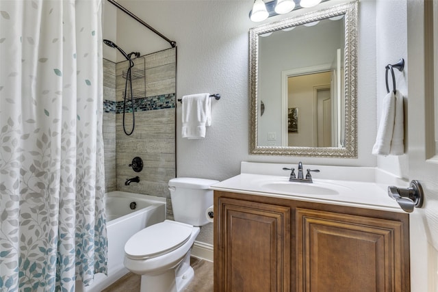 bathroom with vanity, shower / tub combo with curtain, a textured wall, and toilet