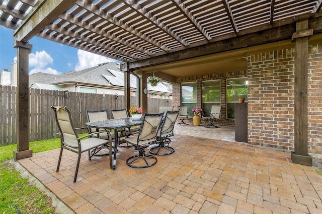 view of patio / terrace with outdoor dining area, a fenced backyard, and a pergola