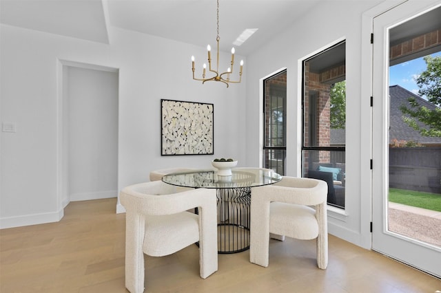 1750 Greenwood Ct, Prosper, TX 75078 - dining space featuring light wood-style flooring, baseboards, and an inviting chandelier