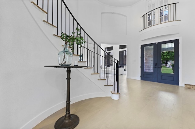 1750 Greenwood Ct, Prosper, TX 75078 - foyer entrance featuring french doors, a towering ceiling, baseboards, wood finished floors, and stairway