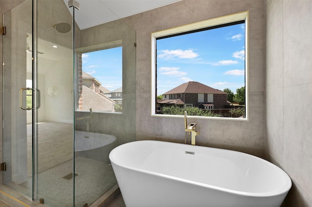 1750 Greenwood Ct, Prosper, TX 75078 - bathroom with a shower stall, a freestanding bath, and tile walls