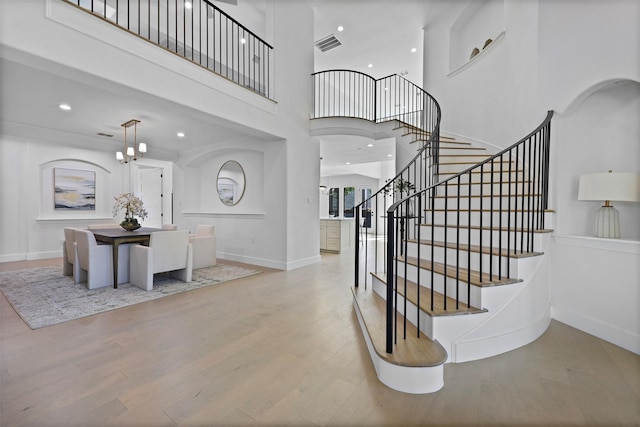 1750 Greenwood Ct, Prosper, TX 75078 - entryway with stairway, a towering ceiling, wood finished floors, visible vents, and baseboards