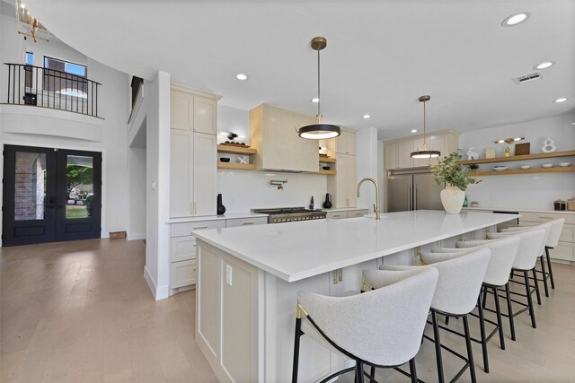 1750 Greenwood Ct, Prosper, TX 75078 - kitchen with light countertops, open shelves, a large island with sink, and stainless steel built in fridge