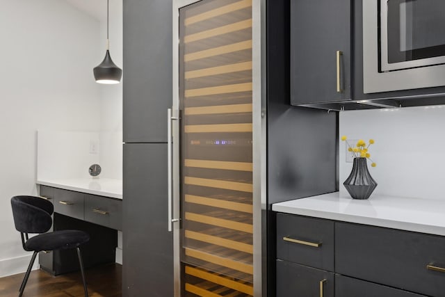 interior space with stainless steel microwave, beverage cooler, and wood finished floors