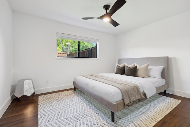 bedroom featuring baseboards, a ceiling fan, and wood finished floors