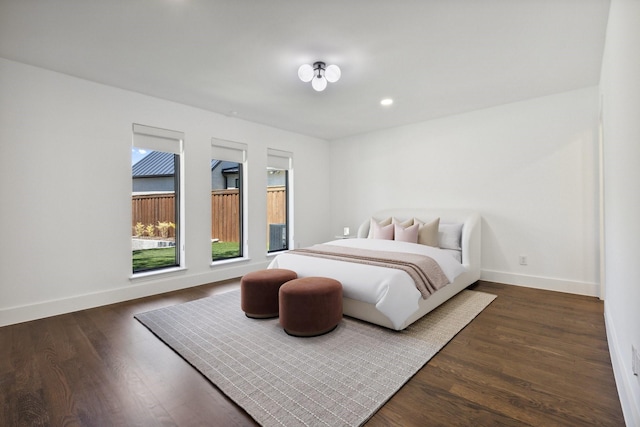 bedroom with recessed lighting, dark wood finished floors, and baseboards