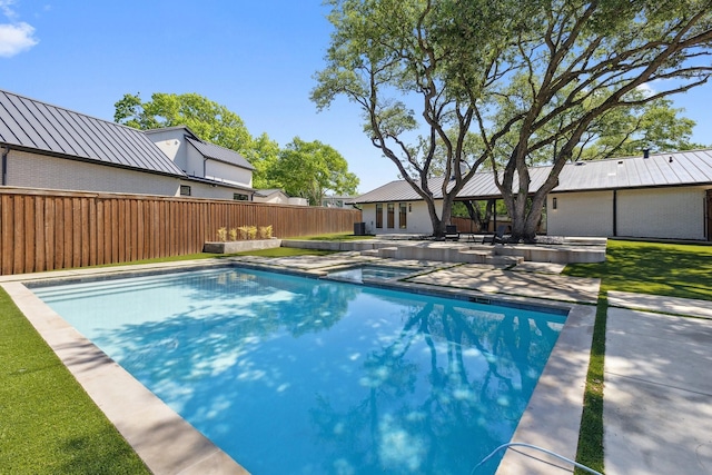 view of swimming pool featuring a fenced in pool, a patio, fence, and an in ground hot tub